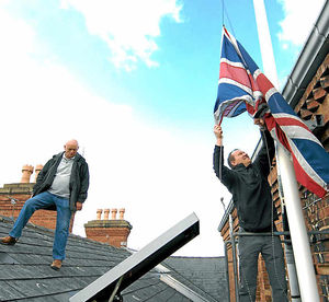 Maintenance boss Phil Morris lowers the flag