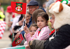 A Wrexham fan waves a flag during a victory parade 