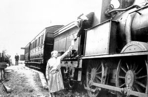 Mrs Bason, who was station master /mistress of Eaton Station, near Lydbury North. Details are: 'Bishop's Castle Railway: Mrs Annie Bason, station master at Eaton Station, handing a letter to driver George Hotchkiss. Tom Cadwallader, guard, at rear of train. Photo taken on February 24, 1932, by General Picture News, shared by Ken Lucas, Archivist of Bishop's Castle Railway Society. Eaton station was demolished in 1936.