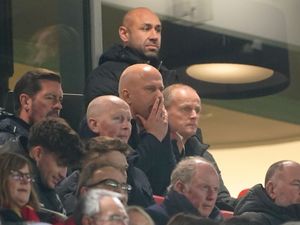 Arne Slot watches from the stands with his hands over his mouth