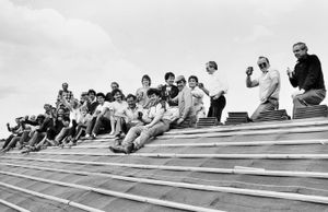 A July 1985 picture of a topping out ceremony at the old Brookhill Crescent, Ketley: 'Drinks on the house... A barrel of beer was hoisted to the top of a residential block in Telford to mark the completion to roof level of one of the phases of a big housing facelift scheme. Wrekin Council are converting the old flats in Brookhill Crescent, Ketley, into smart new two-storey houses and yesterday men from the contractors, Frank Galliers of Shrewsbury, lined the rooftop to toast their success in a traditional topping-out ceremony.' The new houses were renamed Wedgewood Crescent.