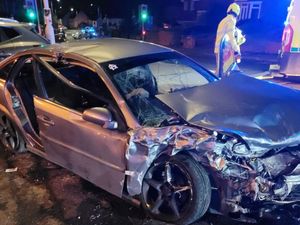 Supporting image for story: Two rushed to hospital and one cut free after car hits parked vehicle