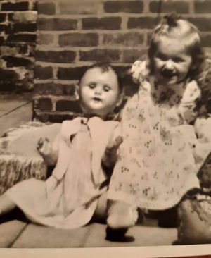 Dianne pictured in around 1959 with one of her toys and wearing the dress from one of her dolls