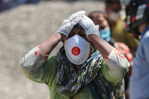 A relative of a person who died of Covid-19 reacts at a crematorium in Jammu, India. Pic: AP Photo/Channi Anand