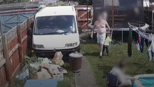 Handout CCTV image issued by North Wales Police of Michael Ives carrying two-year-old Ethan Ives-Griffiths in the back garden of the family home in Garden City, Deeside. Photo: North Wales Police/PA Wire 