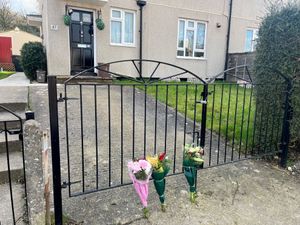 Floral tributes left near the scene on Cobhorn Drive, Hartcliffe, Bristol, where a 19-year-old woman died after she was attacked by a dog