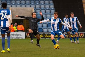 Shrewsbury Town’s Tom Sang challenges Arthur Read. 