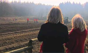 Debbie and Julie watch excavations. They hope a memorial can be erected.