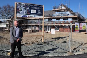 John Green, chief executive of Shropshire Rural Housing, next to a housing development being built in Chirbury. Picture: j&pr