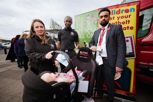 Marianne Gegg from West Midlands Fire Service during a child safety seat demonstration, along with Watch Commander Adrian Spencer and Councillor Rizwan Jalil