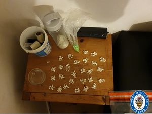 Supporting image for story: 500 wraps of cocaine seized from drug den hidden behind false wall