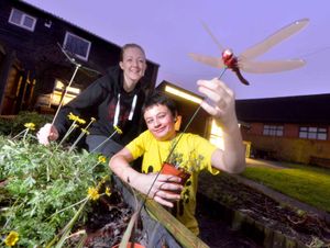 Volunteer Stacey Deakin with Callum Peake 13 in a garden they have helped create
