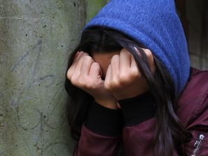 A girl with her head in her hands