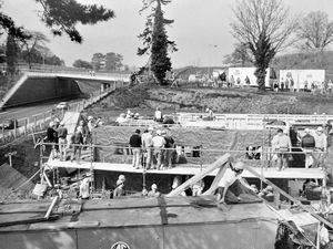 The story pasted on the back of this 1987 print begins: 'Jehovah's Witnesses will hold the first meeting in Bridgnorth's new Kingdom Hall tomorrow - after the building was raised in just over two days. Up to 800 volunteers of all ages, from all over Shropshire and the Midlands, converged on Bridgnorth yesterday morning to start the quick-build project. The hall is being built along the Severn Valley Railway line in Oldbury road'