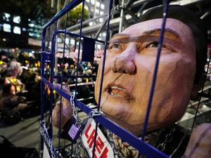 A caricature depicting an imprisoned South Korean President Yoon Suk Yeol is displayed during a rally to demand his impeachment outside the National Assembly