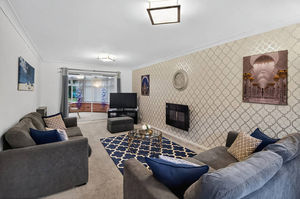 The open-plan kitchen and dining area forms the heart of the home, designed for modern living with space for everyday meals and hosting