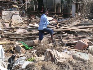 A person clears away debris following the 2004 tsunami, in Galle, southern Sri Lanka