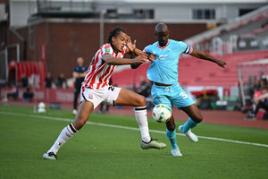 Walsall attacker Albert Adomah grapples for the ball. (Image by Owen Russell)