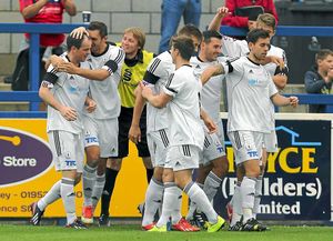 Robbie Booth of AFC Telford United celebrates with his team-mates after scoring a goal to make it 1-0