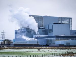 Exterior view of Hunterston B nuclear plant, with steam rising from chimneys