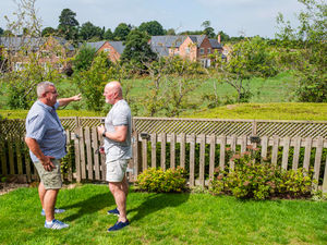 Councillor Andy Hall (left) and Keith Astley look across the proposed housing site, off Chester Road on the outskirts of Whitchurch. Picture: Graham King