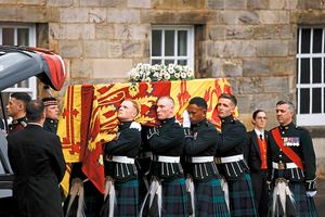 Pallbearers carrying the coffin of Queen Elizabeth II, draped with the Royal Standard of Scotland, as it arrives at Holyroodhouse, Edinburgh