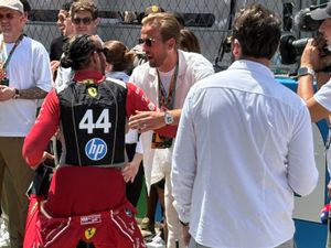 Supporting image for story: Harry Kane greets Lewis Hamilton as England players take in Spanish Grand Prix