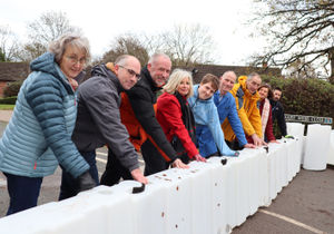 Members of Shropshire Rural Housing and local residents with the new flood barriers.