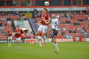 Walsall striker Aaron Pressley battles for the ball against Derby.
