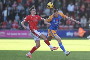 Tom Anderson of Shrewsbury Town battles with Emre Tezgel of Crewe Alexandra