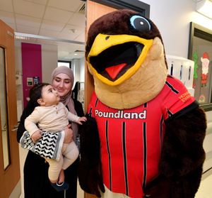 Walsall FC players and mascot Swift visited the town's Manor Hospital to meet staff and patients and give presents out for Christmas.
Yahya Haval, aged seven months meets Swifty.