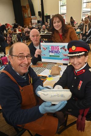 Simon Martin fixes a bowl for Vice Lord Lieutenant Jenny Wynn at The Big Mend. At the back from Veolia is Donald Macphail and Abby Simms