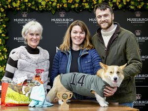 People posing with dog