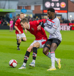 Joel Taylor kept at bay by Matthew Grivosti during Hednesford Town's 1-1 draw against FC United of Manchester on Saturday (Picture: Jim Wall)