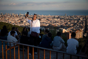 Tourists gather at the Carmel Bunkers scenic viewpoint to enjoy the sunset in Barcelona. (Photo by JOSEP LAGO/AFP via Getty Images)