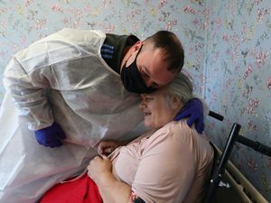 Supporting image for story: Care home residents embrace family and friends during Christmas Day visits