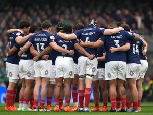 France players with arms around each other in huddle