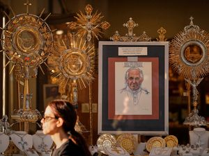 A depiction of the late Pope Francis is placed in a shop window outside the Vatican