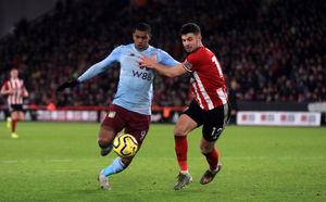 Aston Villa's Wesley (left) and Sheffield United's John Egan battle for the ball