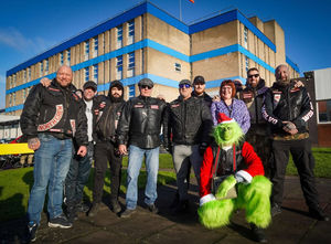 Members of Wolverhampton Hell's Angels meet the Grinch ahead of delivering toys to the Children's Hospital