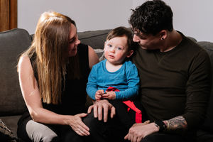 Councillor Jay Moore, pictured at his home with his partner Poppy King and their son Alfie Moore