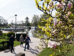 People walk during a bright morning in Stratford-upon-Avon, Warwickshire