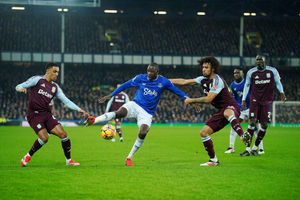 Everton's Abdoulaye Doucoure battles for the ball with Aston Villa's Boubacar Kamara and 