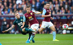 Burnley's Ashley Barnes (left) and Aston Villa's Frederic Guilbert 