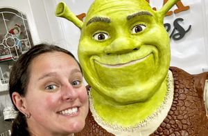 Lara Mason and her life-sized Shrek cake. The mum-of-two said the cake was so big that most of the decorating process needed to be done while balancing atop a set of ladders
