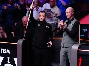 Mark Allen, left, celebrates scoring a maximum break of 147 during his match with Chris Wakelin on day seven of the Halo World Snooker Championship at the Crucible