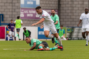 Adam Walker Running through midfield being tackled by a Notts County player Pic: Kieren Griffin Photography