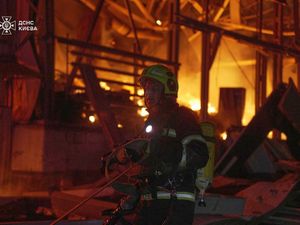 Emergency services personnel work to extinguish a fire in Kyiv