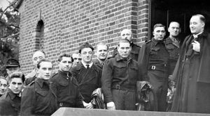December 1946, handwritten on the back in ink is: 'War - POWs. German P.O.W.s attending mass at St Mary's RC Church at Cannock on Christmas morning were received by Rev B Hickson (Priest-in-Charge).' The caption pasted on the back reads: 'Bringing with them toys they had made for distribution among poor children in Cannock, over 200 German Catholics from the prisoners of war camp at Penkridge attended a celebration of Mass by Father B. Hickson at St Mary's Roman Catholic Church, Cannock, on Christmas morning. Before returning to Penkridge they were served with tea and cigarettes in St Mary's Parish Room. Picture shows them at the church door.'  Picture: Fred Parsons, Photographer & Picture Framer.