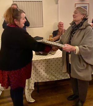Hall chairman Elena Cassidy-Smith over a print of Willey Village Hall to Lady Catherine during the evening